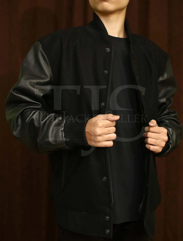 Classic black varsity jacket with leather sleeves