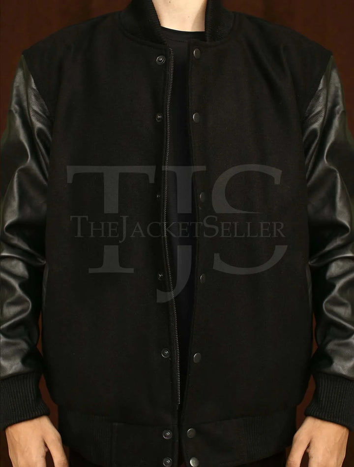 All-black varsity jacket with ribbed cuffs and collar