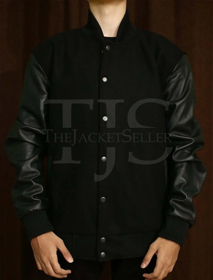 Men's black varsity jacket featuring wool body and leather sleeves