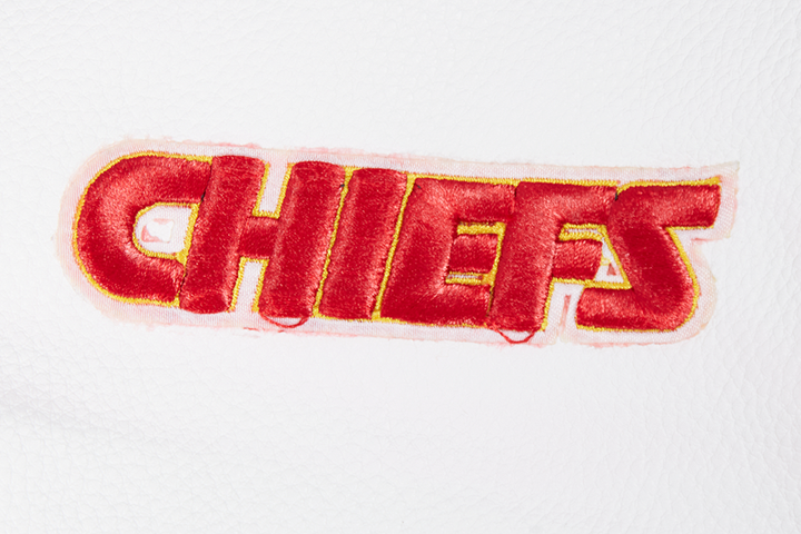 Close-up of embroidered Chiefs text on a red varsity jacket