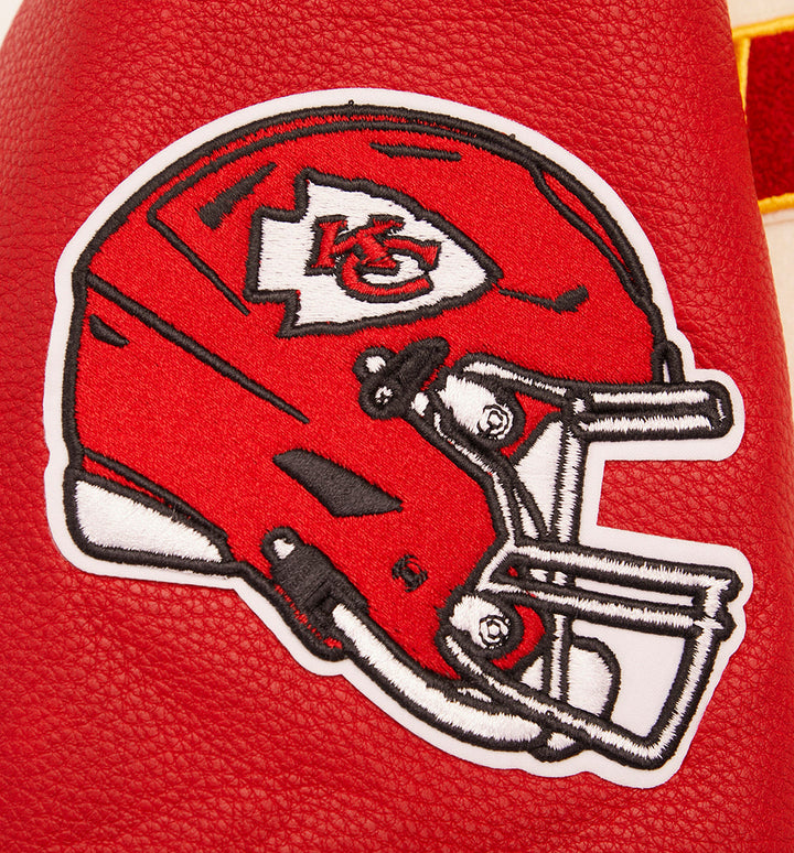 Detailed view of Kansas City Chiefs helmet logo on wool varsity jacket.