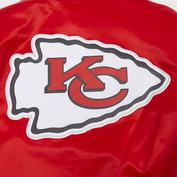 Kansas City Chiefs logo patch on red jacket.
