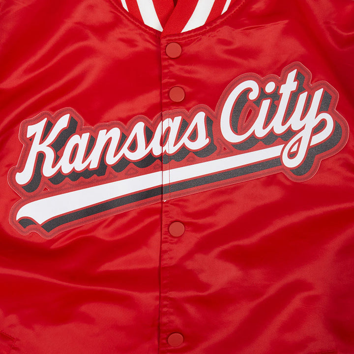 Close-up of Kansas City script logo on the front of the red jacket.